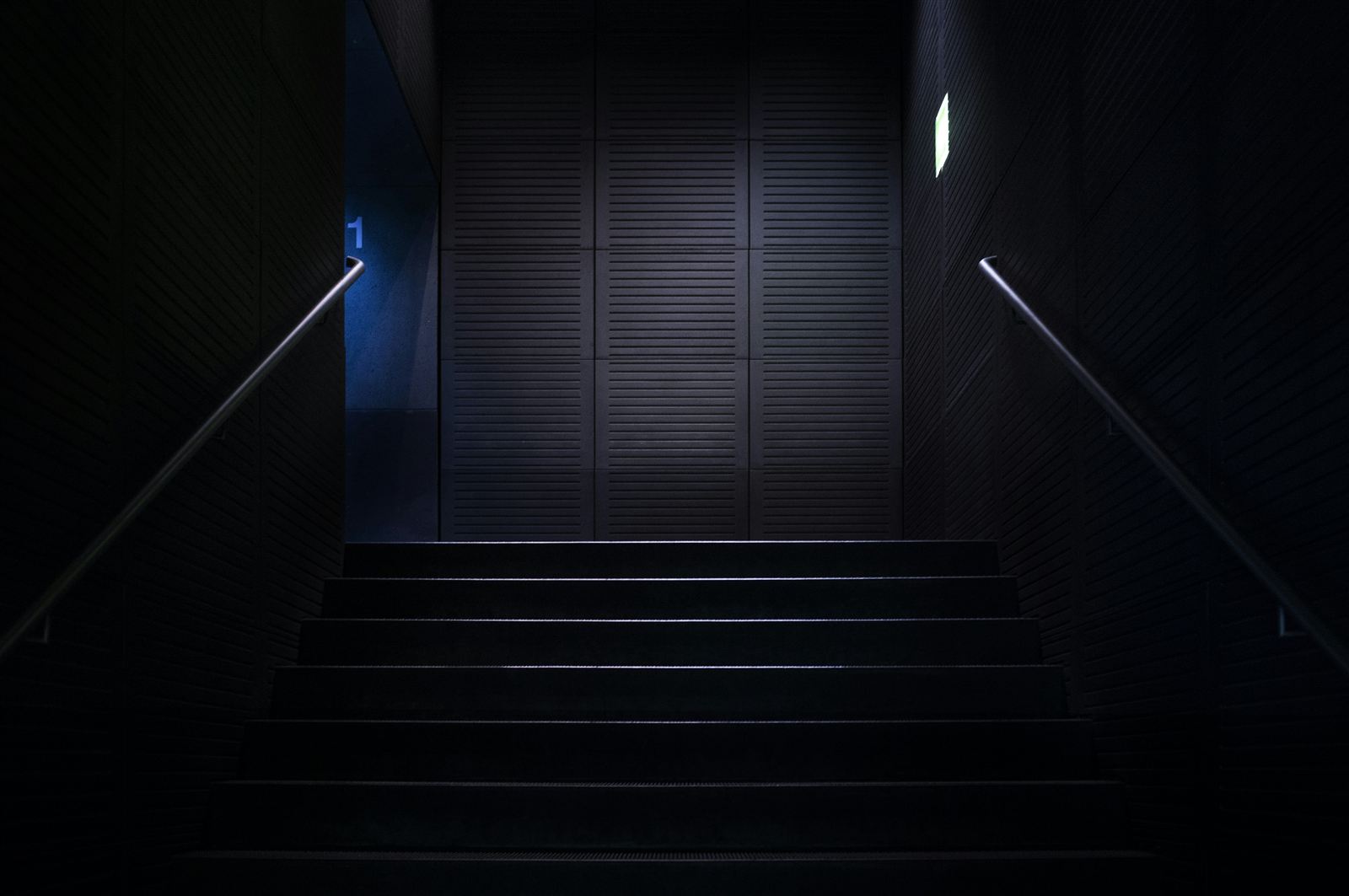 A bright stairwell opening onto daylight, evoking a clinic corridor at shift change.